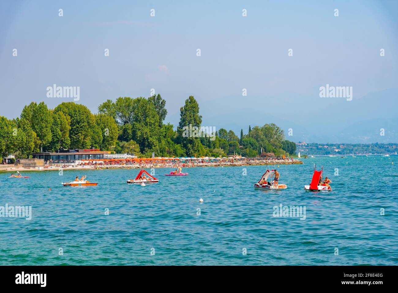 DESENZANO DEL GARDA, ITALY, JULY 21, 2019: People are enjoying a sunny day at a beach in Desenzano del Garda in Italy Stock Photo