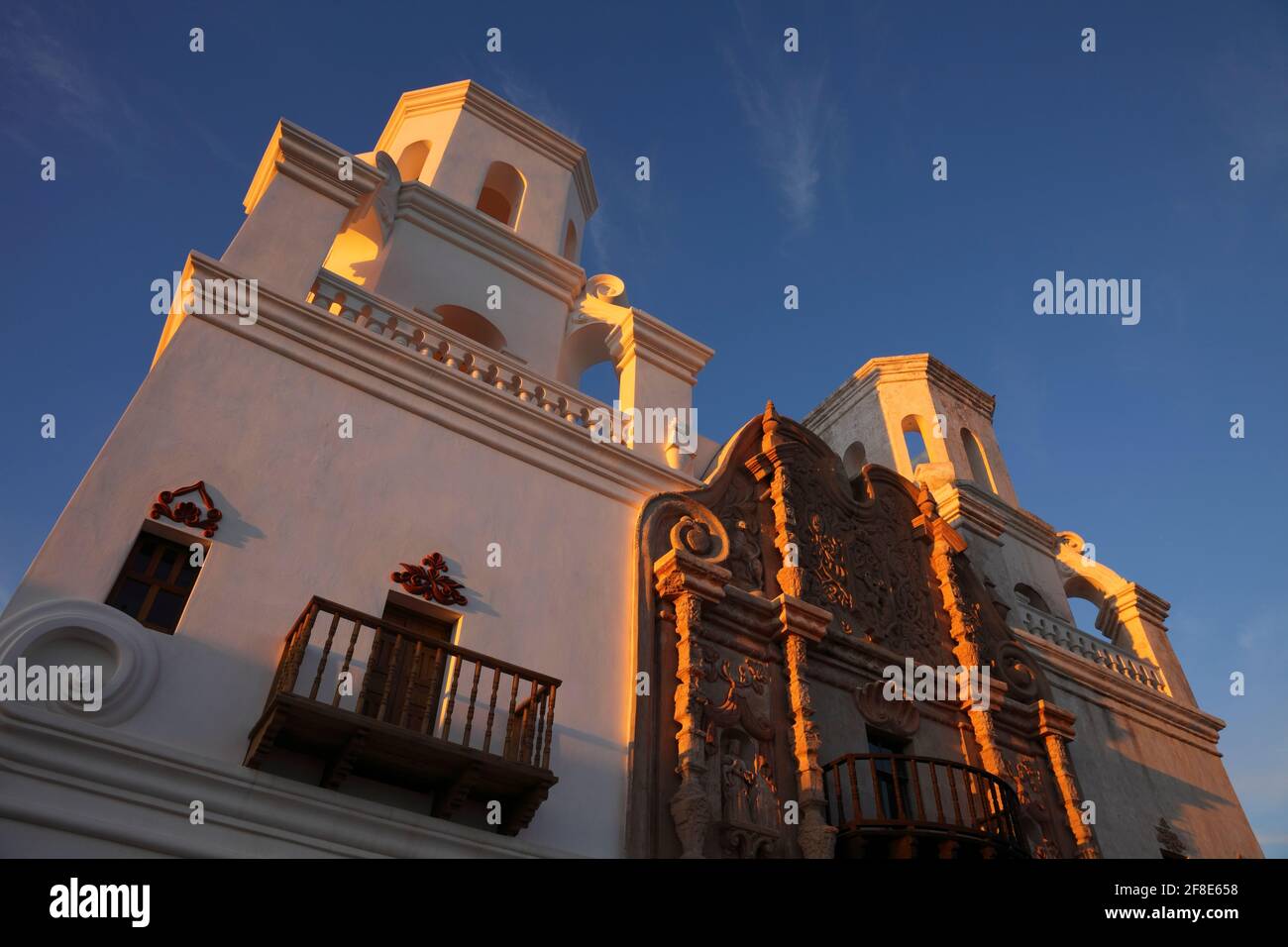 Tohono O'Odham Indian Reservation  AZ / OCT A converging perspective wide angle view looking up a at San Xavier Mission in the warm last light. Stock Photo