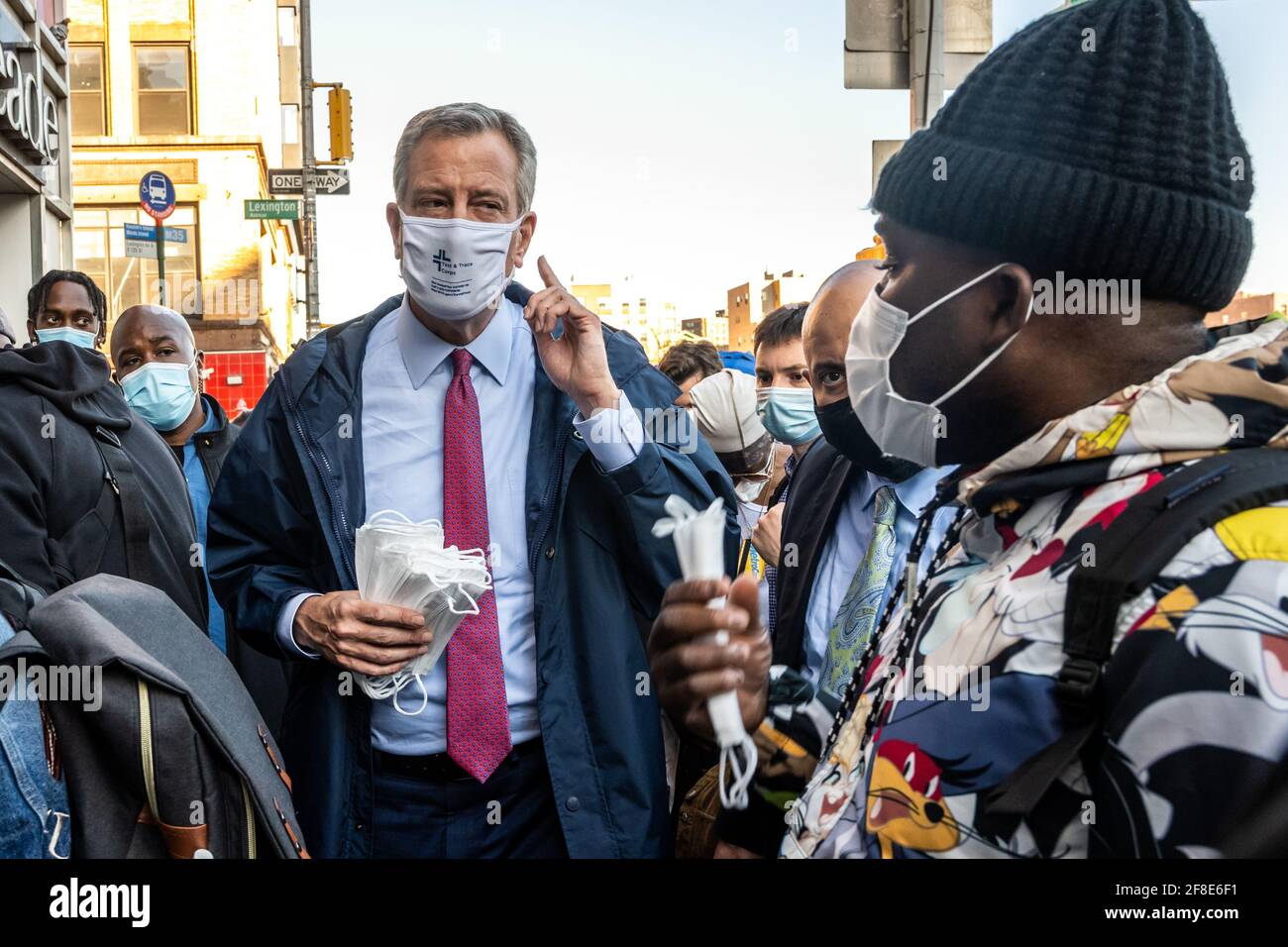 New York, USA. 13th Apr, 2021. New York City's Mayor Bill de Blasio talks to local residents as he joins outreach workers for an event to distribute face masks and set up COVID-19 vaccination appointments in a Spanish Harlem street. Credit: Enrique Shore/Alamy Live News Stock Photo