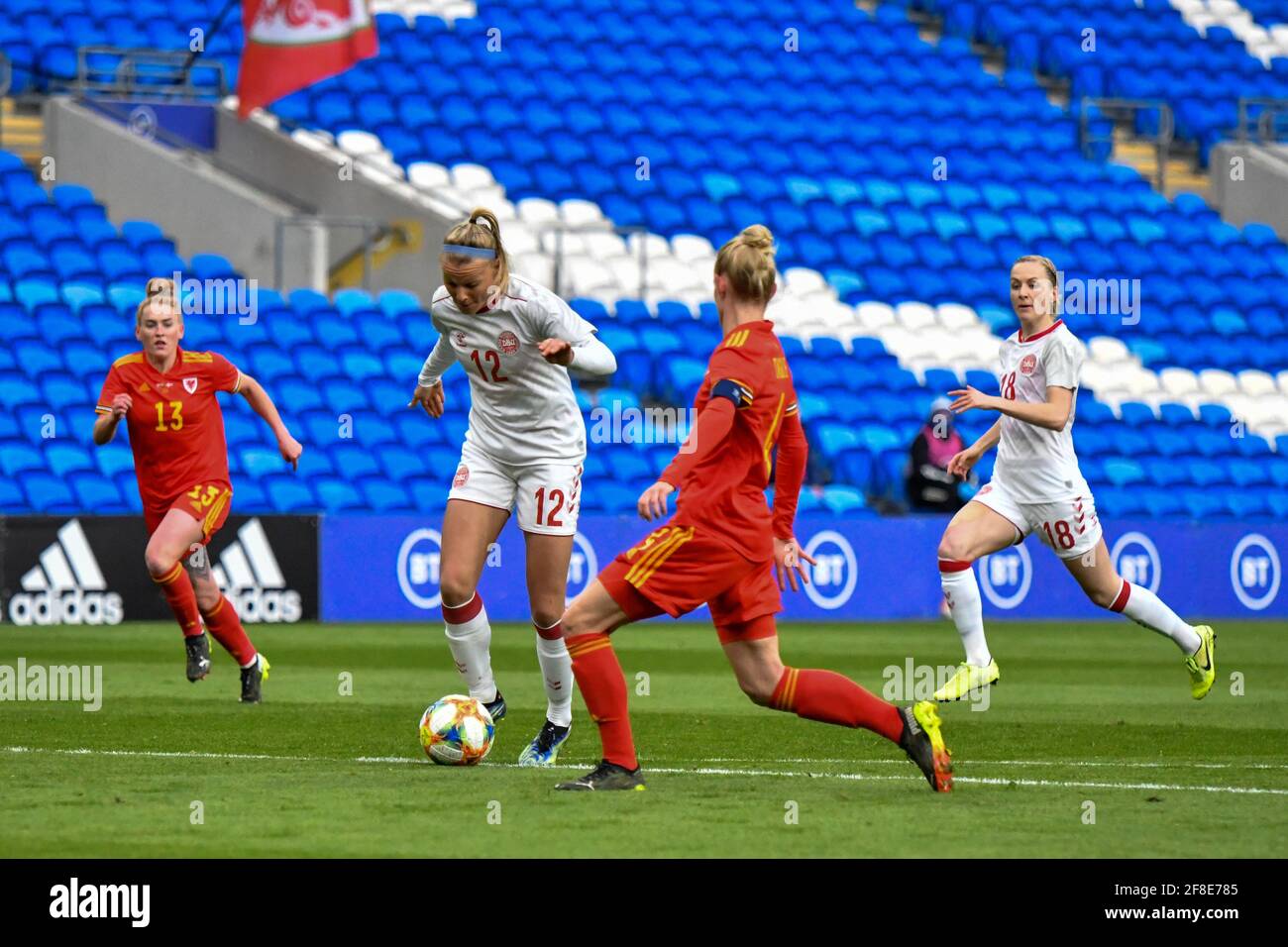 Cardiff, Wales. 13 April, 2021. Stine Larsen of Denmark Women under pressure from Sophie Ingle of Wales Women during the Women's International Friendly match between Wales and Denmark at the Cardiff City Stadium in Cardiff, Wales, UK on 13, April 2021. Credit: Duncan Thomas/Majestic Media/Alamy Live News. Stock Photo