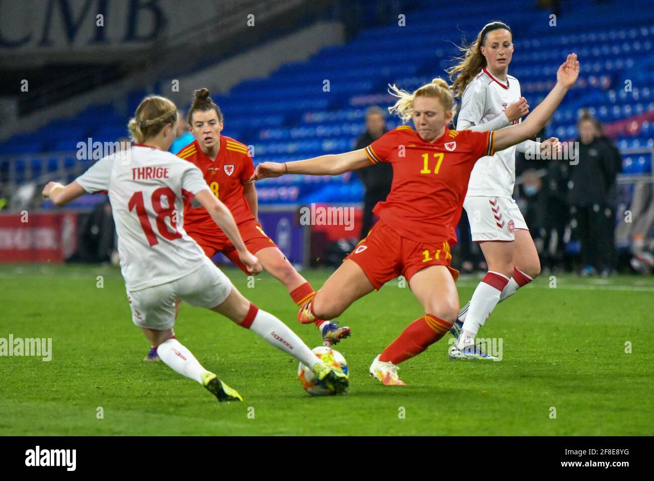 Cardiff, Wales. 13 April, 2021. Sara Thrige of Denmark Women is tackled by Ceri Holland of Wales Women during the Women's International Friendly match between Wales and Denmark at the Cardiff City Stadium in Cardiff, Wales, UK on 13, April 2021. Credit: Duncan Thomas/Majestic Media/Alamy Live News. Stock Photo