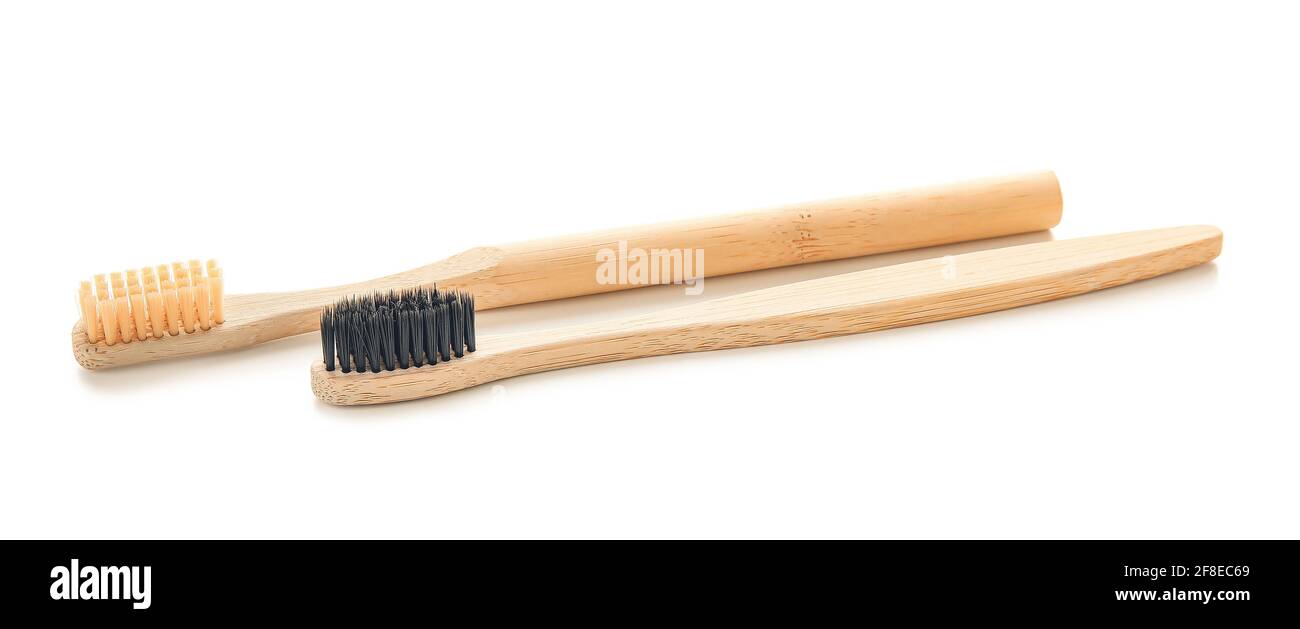 Wooden tooth brushes on white background Stock Photo - Alamy