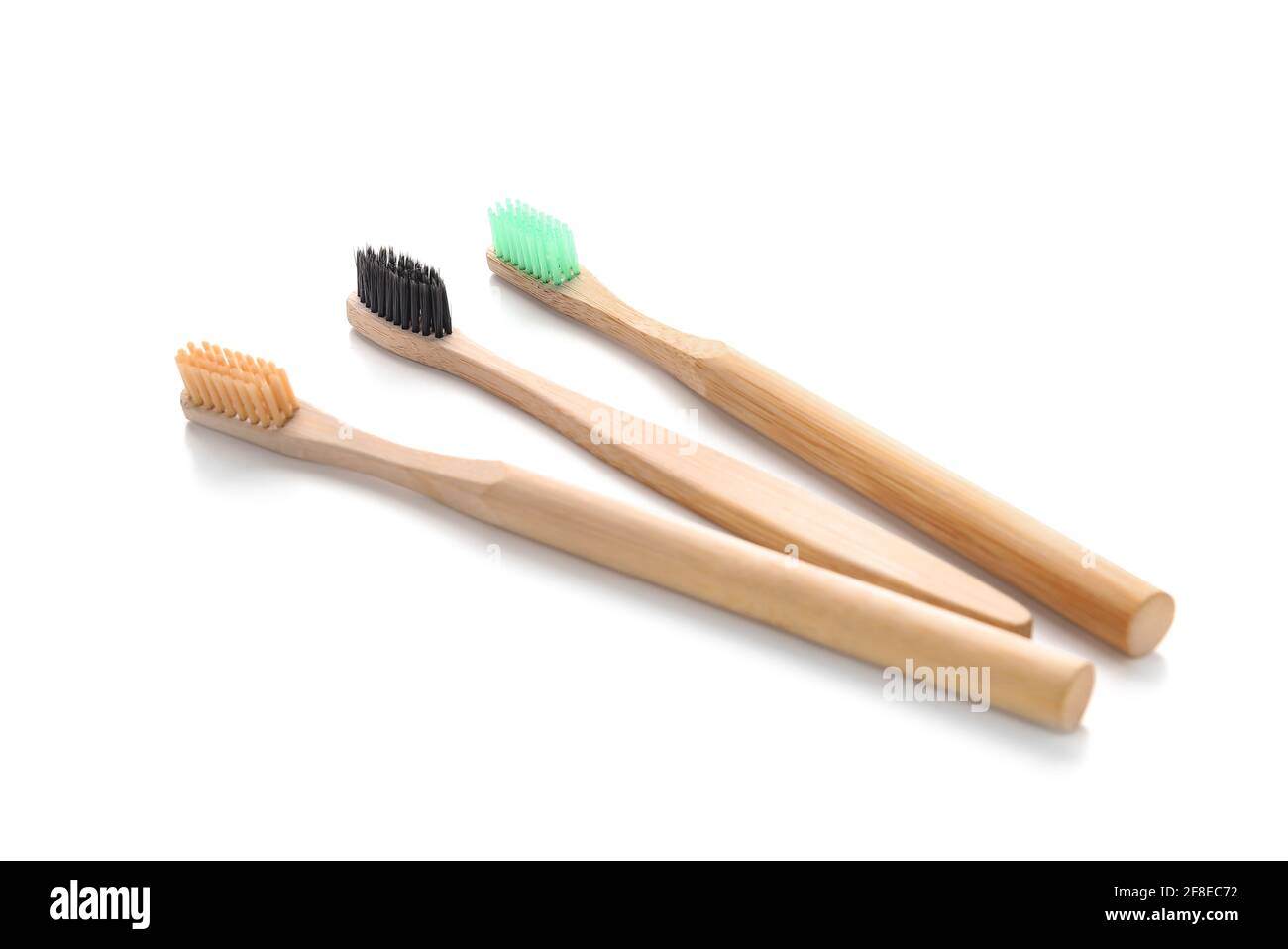 Wooden tooth brushes on white background Stock Photo - Alamy