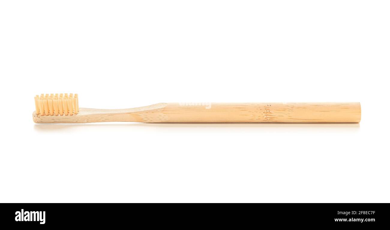 Wooden tooth brush on white background Stock Photo - Alamy