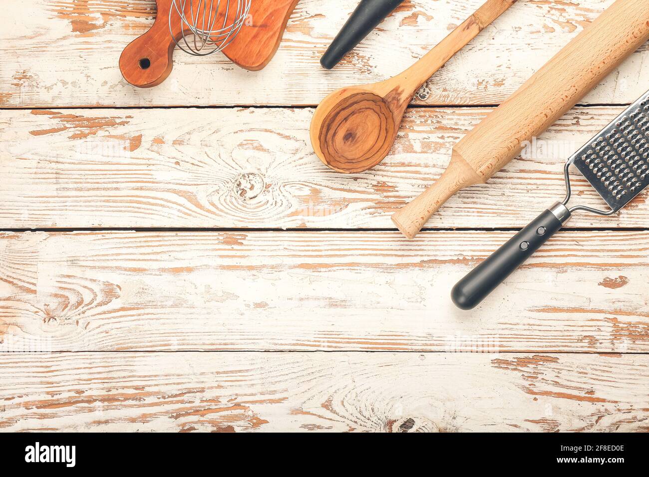Set of kitchen utensils on light wooden background Stock Photo - Alamy
