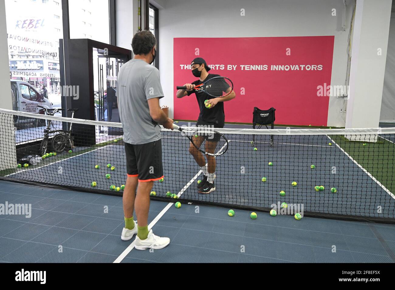 Manhattan, New York, NY, April 13, 2021. Philip Hinder (grey shirt)  participates in a group tennis class at the Tennis Innovator courts located  on 8th Avenue in Midtown Manhattan, New York, NY,