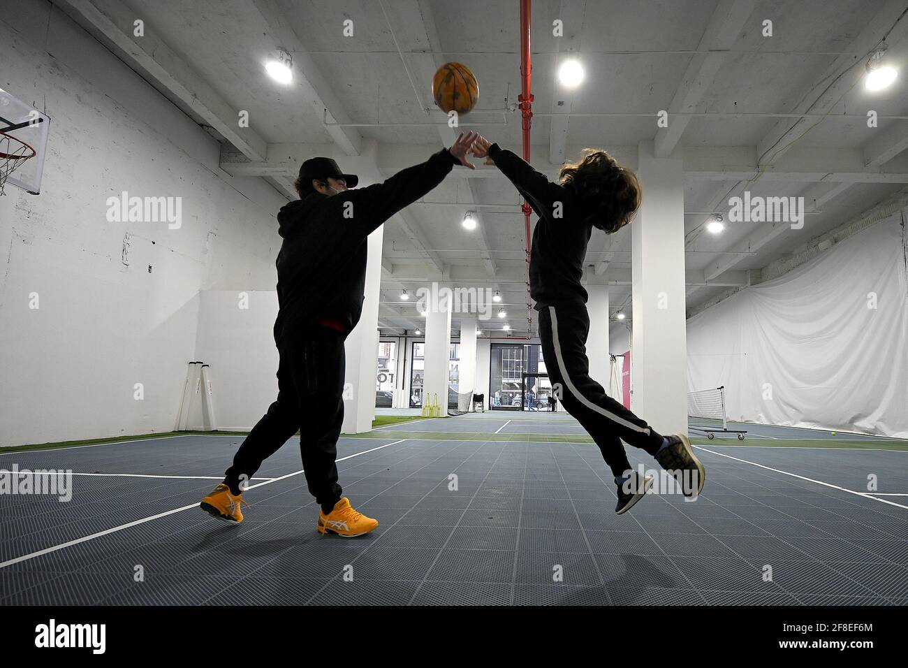 Turning 11 years-old this week, Dylan (r) plays one-on-one baskeball with  coach Sam Scrbner (l) at the Tennis Innovator courts located on 8th Avenue  in Midtown Manhattan, New York, NY, April 13,
