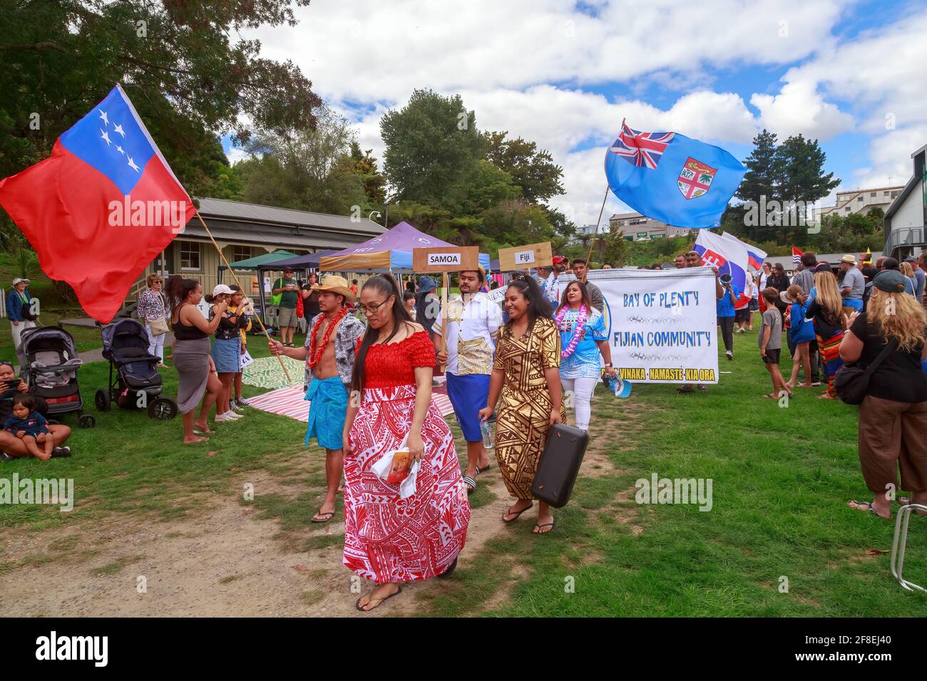 People from Samoa and Fiji carrying their national flags and taking part in a multicultural parade. Tauranga, New Zealand Stock Photo