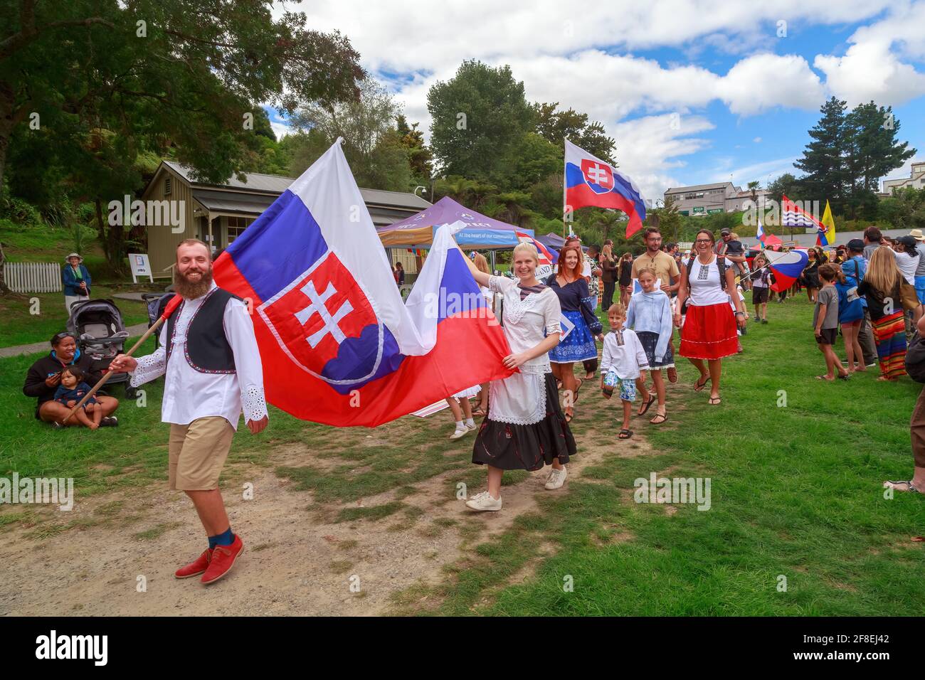 Slovakian people in traditional folk costume and carrying the flag of Slovakia at a multicultural festival. Tauranga, New Zealand Stock Photo