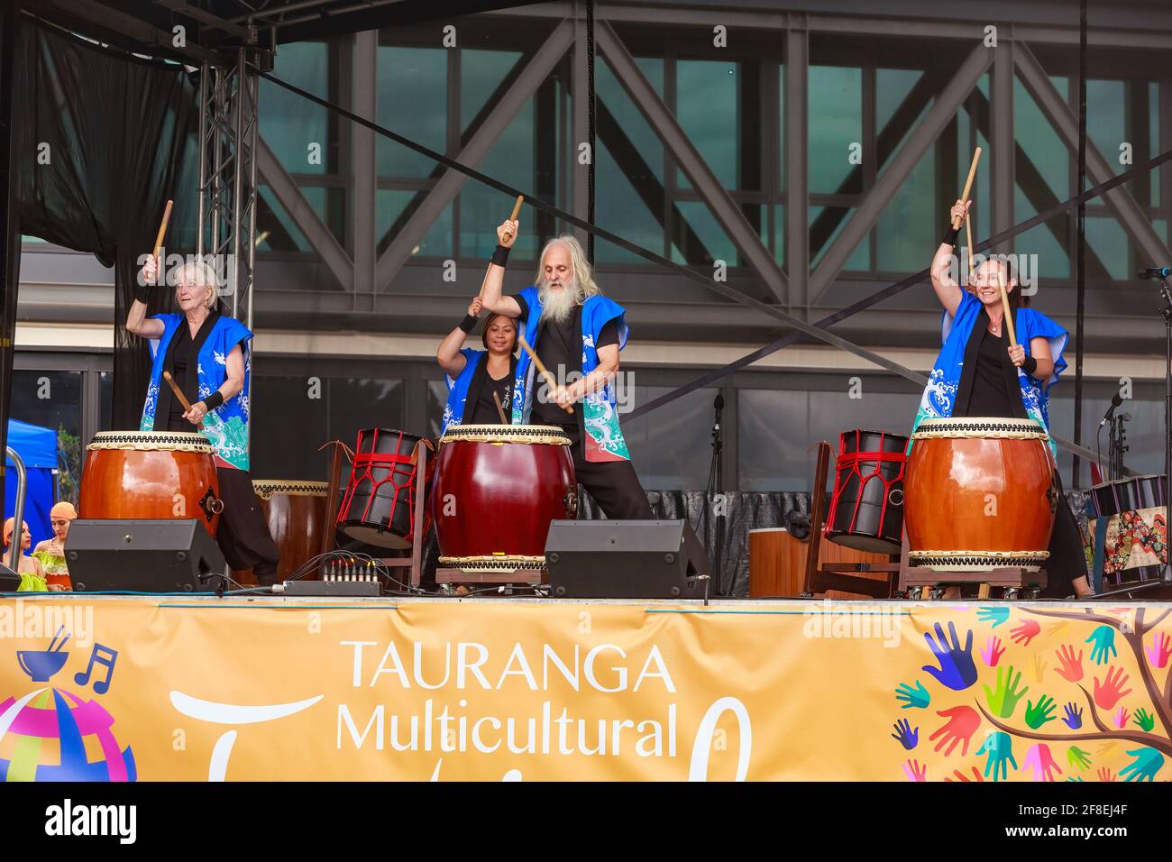 A group of musicians playing taiko (traditional Japanese wooden drums) on stage. Photographed at a multicultural festival in Tauranga, New Zealand Stock Photo