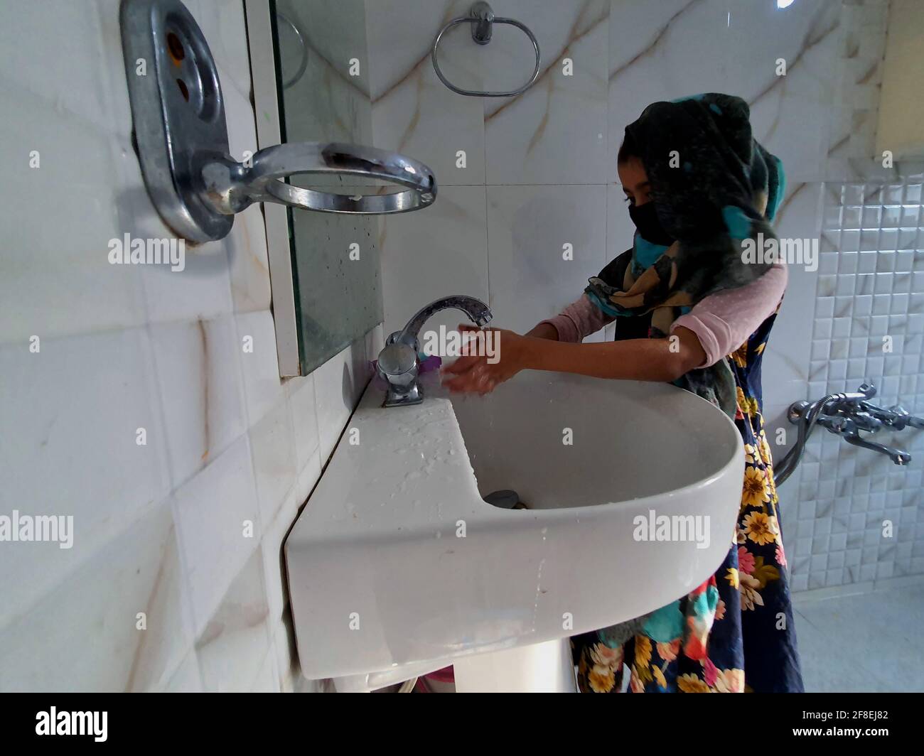 Masked kids washing hands during coronavirus lock down in india Stock