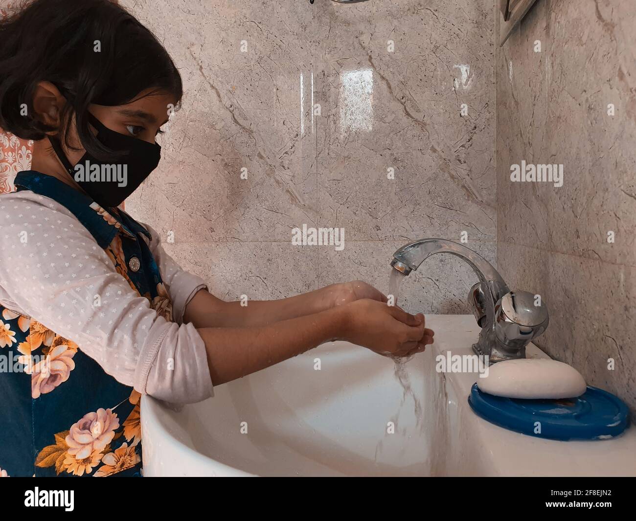 Image of Washing Hands In Bathroom By Masked Children During
