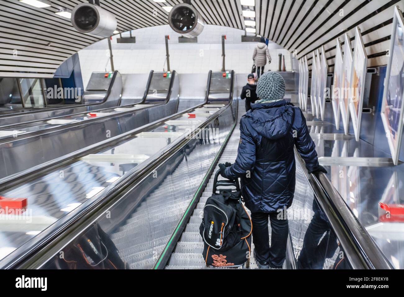 Woman in the escalator going to metro platforms in Helsinki Finland Stock Photo