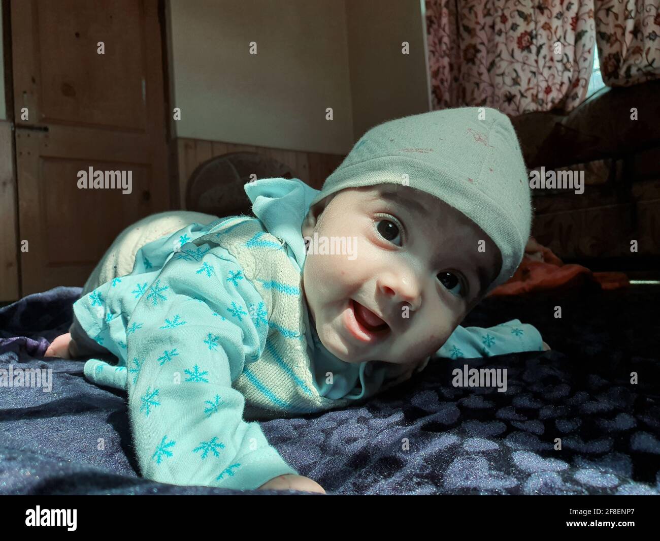 Beautiful kid different poses looks very handsome. Small child after born have soft cheeks and innocent small face with a shing smile. Stock Photo