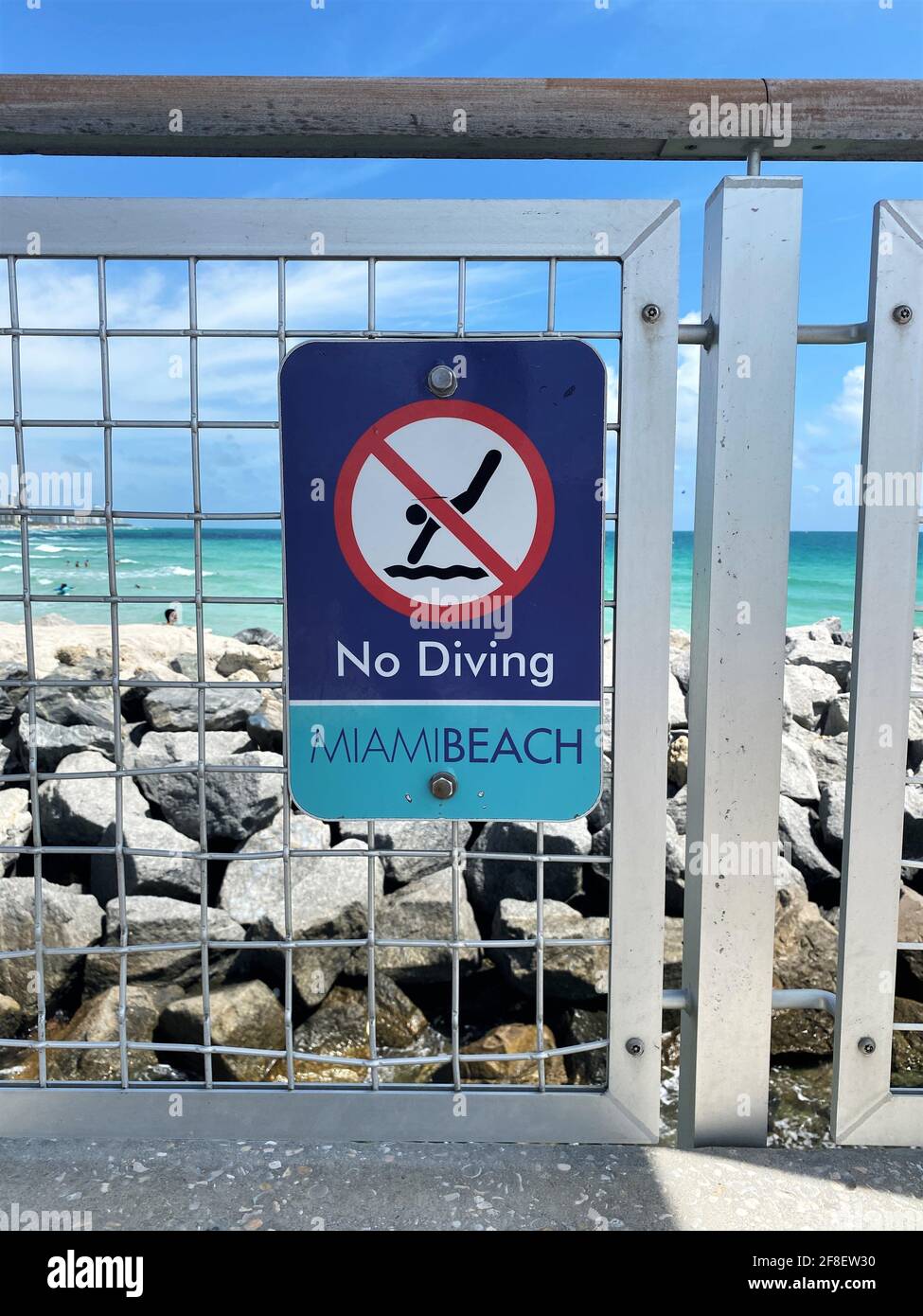 South Pointe Pier in Miami Beach, Florida sign for no diving allowed. Too many rocks and very dangerous. Stock Photo