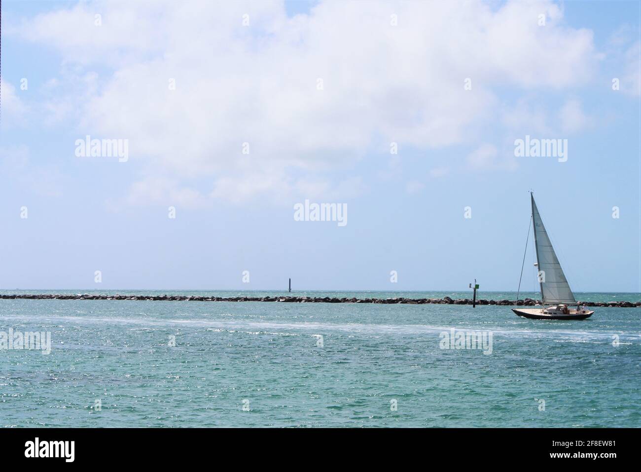 Beautiful Sailboat Sailing At Low Tide With Passengers Aboard Navigating Through The Wind In Miami Beach Florida Near South Pointe Pier Copyspace Stock Photo Alamy