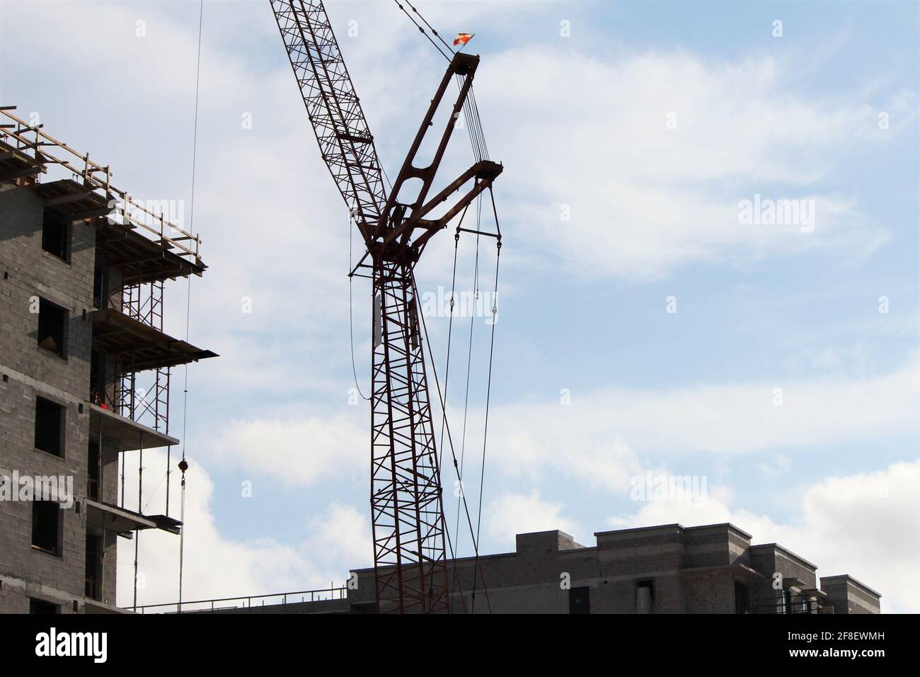 Cranes and equipment being used for construction site. Apartment