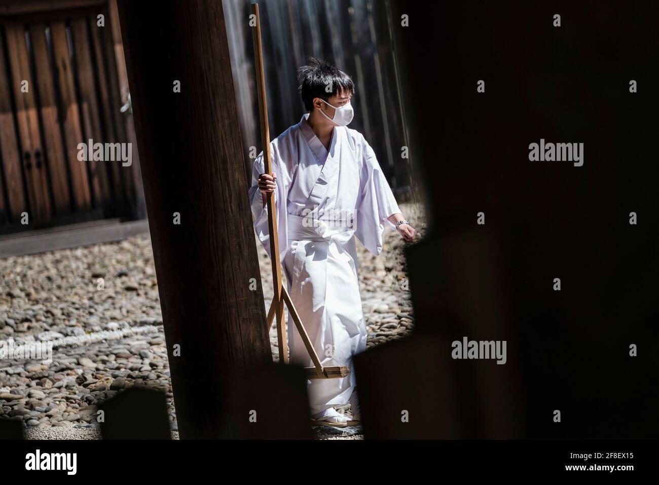 APRIL 14, 2021 - A shinto priest is seen wearing a mask to prevent the spread of coronavirus at Atsuta Jingu, a major shrine in Nagoya, Aichi Prefecture, Japan. The government of Aichi prefecture plans to ask the central Japanese government for quasi-emergency measures to be implemented, as the prefecture is experiencing a spike in the number of daily new coronavirus cases. With 100 days to go until the Olympics, regions around the country are seeing an uptick in Covid-19 cases. Credit: Ben Weller/AFLO/Alamy Live News Stock Photo