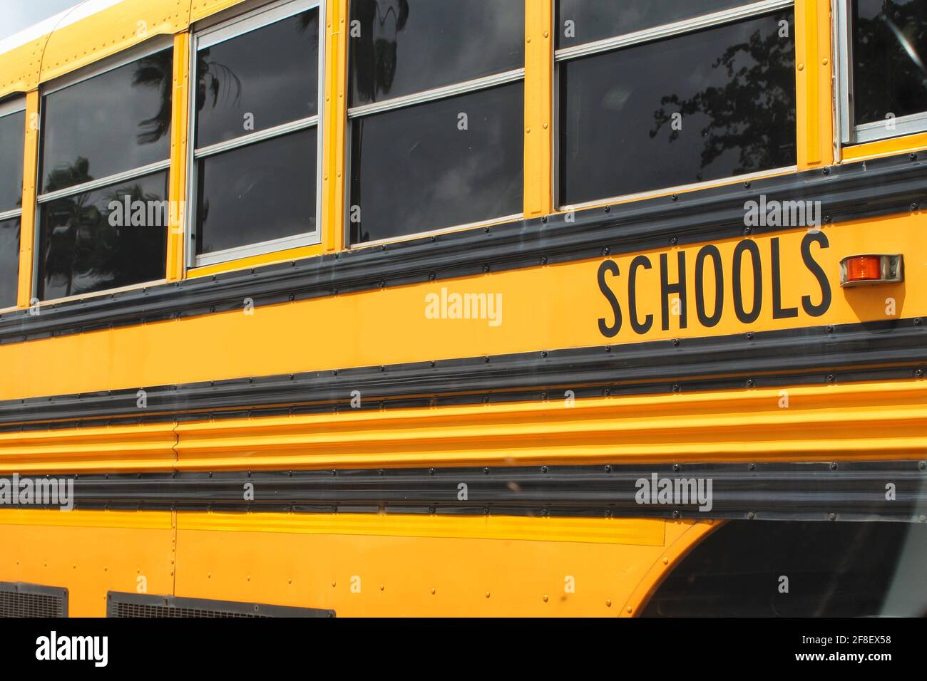 Yellow school bus from a county public school system parked in a parking lot Stock Photo