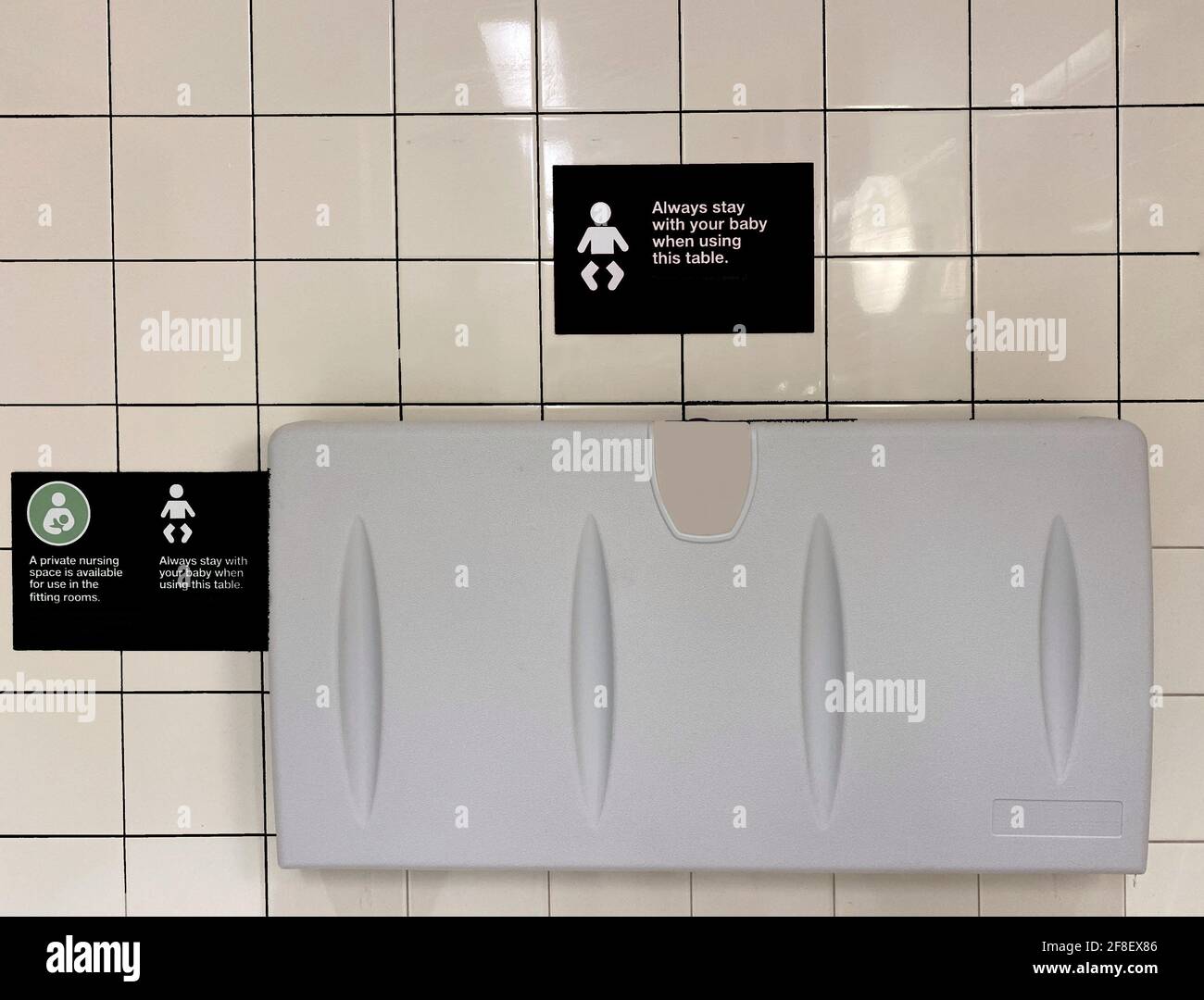 Child diaper table in a public restroom. Baby changing board by the