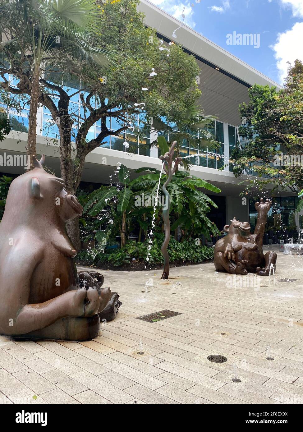 Gorillas in the Mist a whimsical public work by The Haas Brothers for Aventura Mall. Three large-scale bronze monkeys and four massive bronze trees Stock Photo