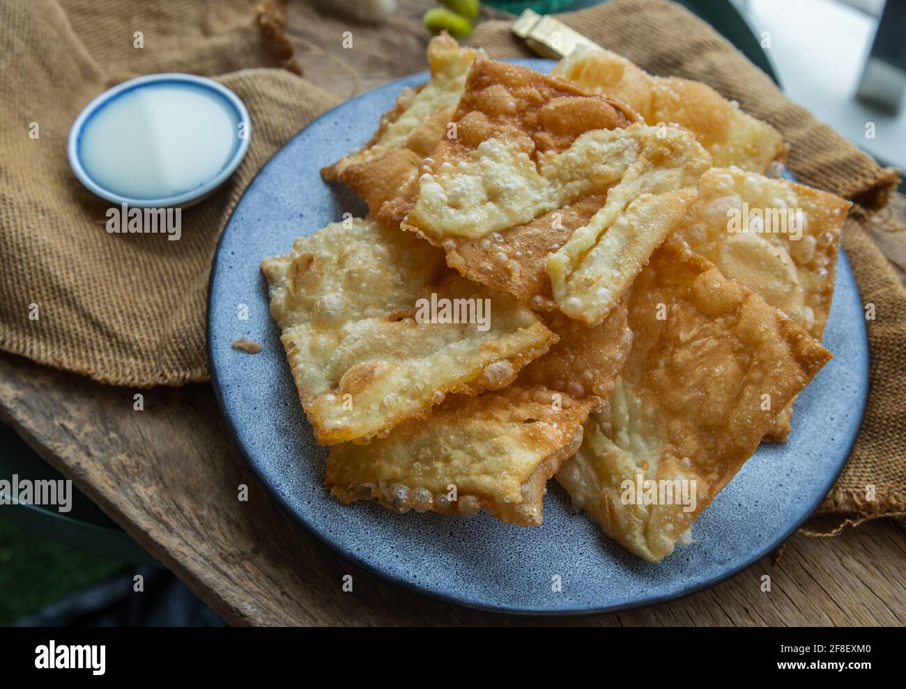 https://c8.alamy.com/comp/2F8EXM0/homemade-sweet-crispy-thai-roti-thai-pancake-served-with-sweetened-condensed-milk-on-ceramic-plate-delicious-thai-dessert-selective-focus-2F8EXM0.jpg