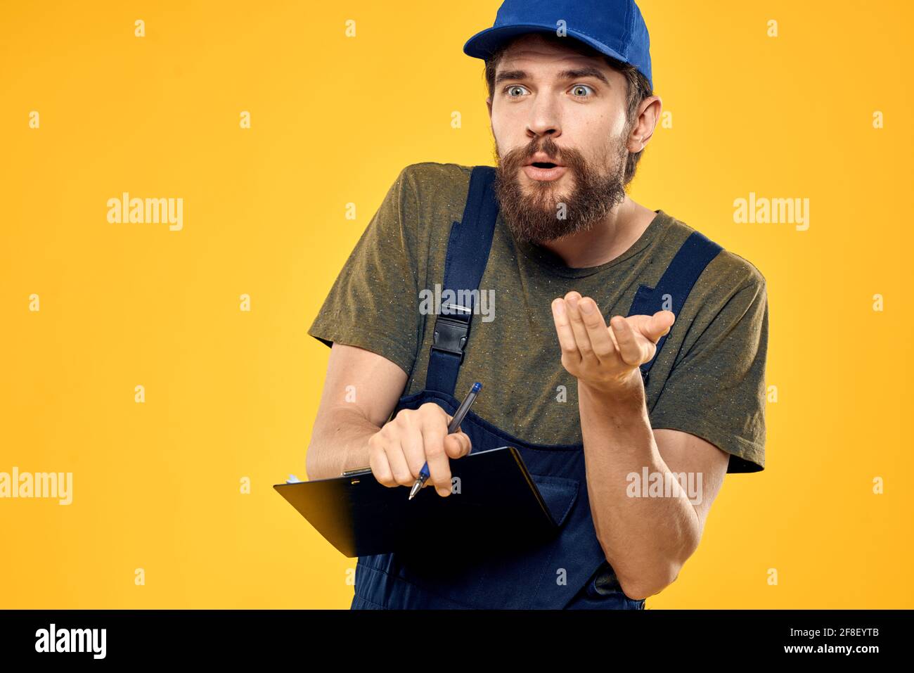 Service Man Images man in professional service uniform yellow background Stock Photo - Alamy