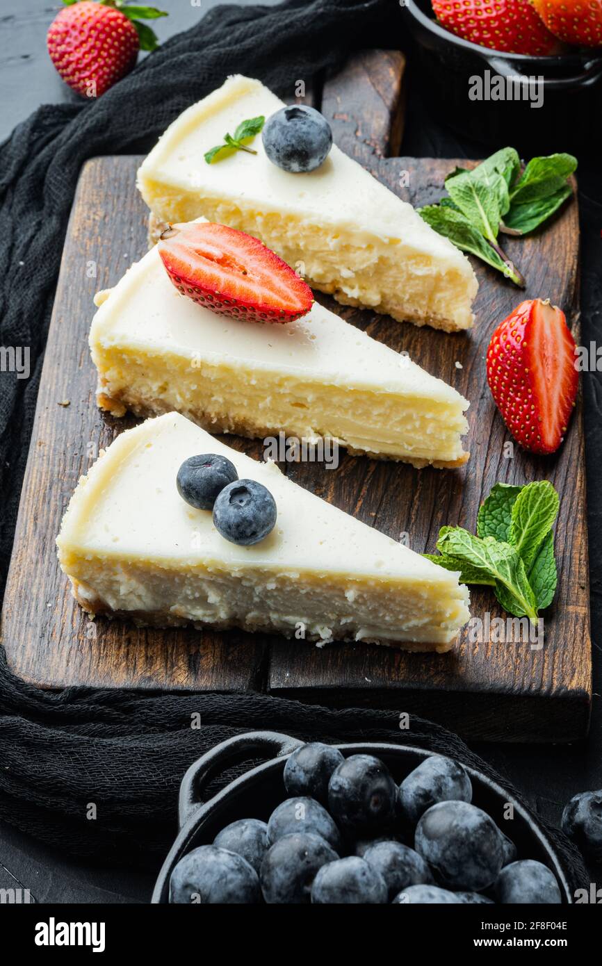 Classic New York Cheesecake, sliced, on black background Stock Photo ...