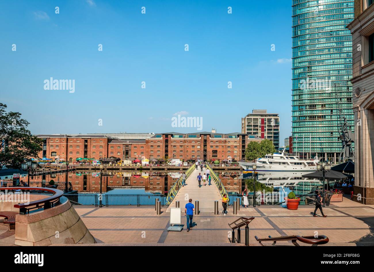 London, UK - August 23 2019: View of the West India Quay, the North Dock and the North Dock pedestrian bridge in Canary Wharf Estate. Stock Photo