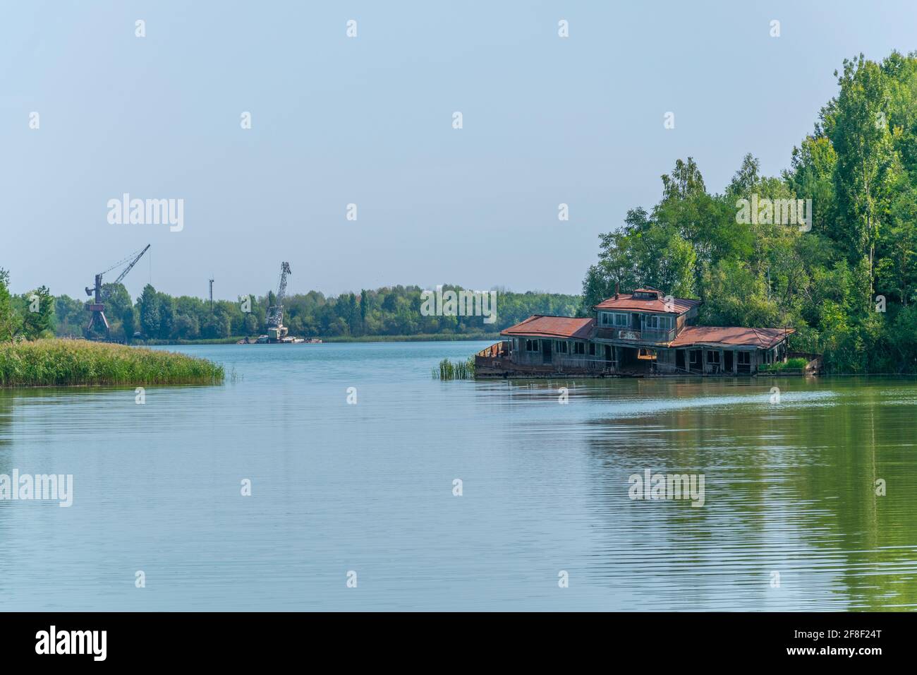 Broken house sunken into Pripyat river in the Ukraine Stock Photo