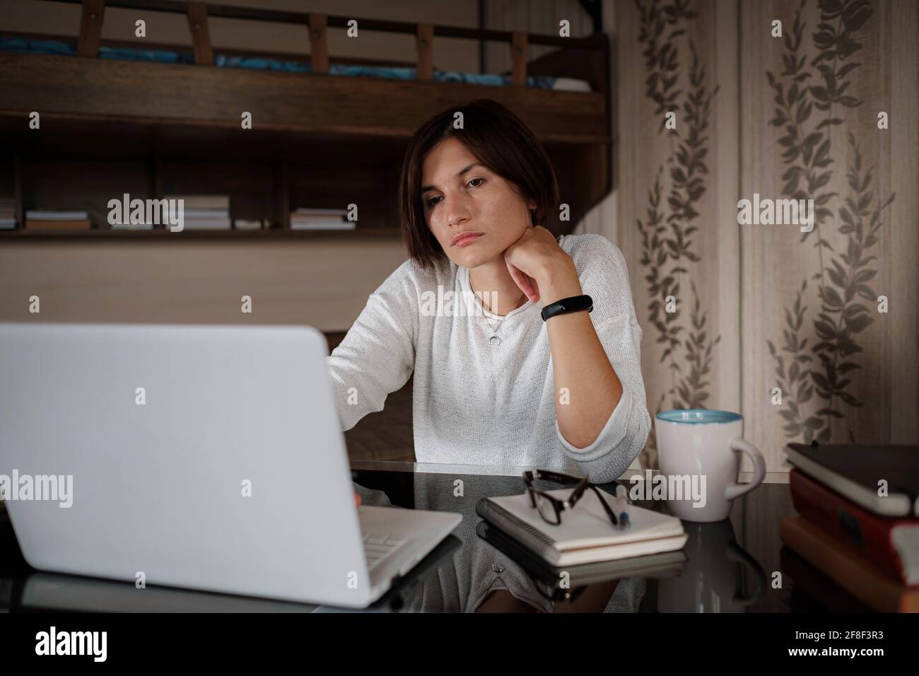 Beautiful asian young woman working on laptop computer while sitting at ...