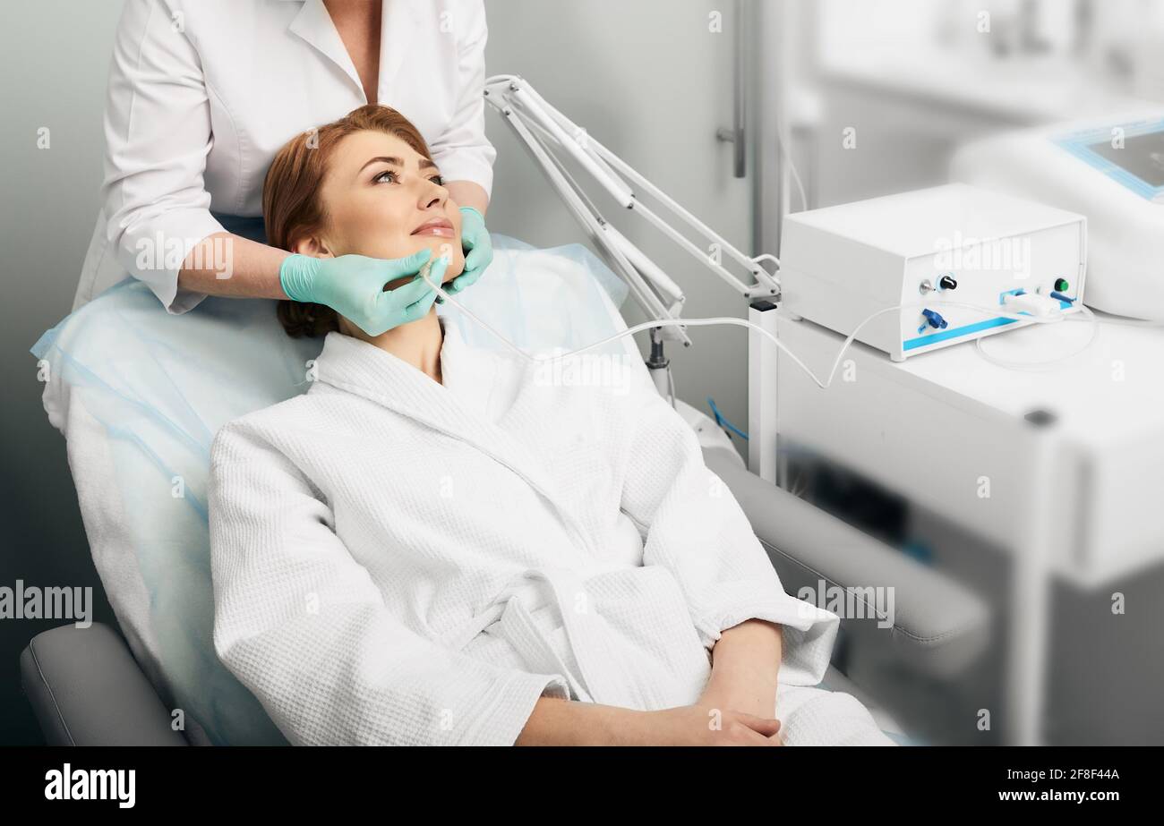 Facial ozone therapy. Woman during rejuvenation skin face with ozone therapy procedure Stock Photo