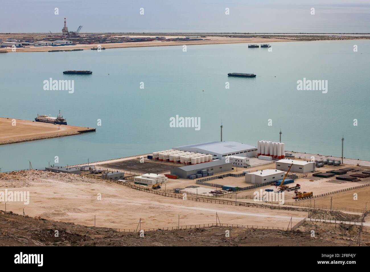 Seaport Bautino. Oil loading terminal for tanker ships. Oil derrick on horizon. Bautino bay, Caspian sea, Kazakhstan. Panorama view. Stock Photo