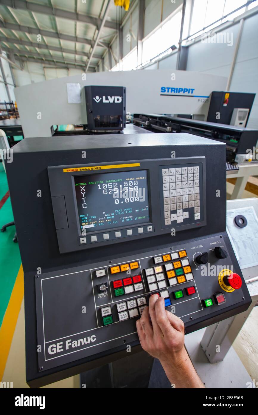 Aktau, Kazakhstan.CNC laser cutting machine control panel and worker's