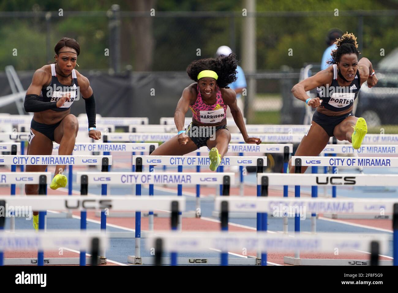 Kendra Harrison aka Keni Harrison (USA), center, defeats Cindy Sember (GBR), left, and Tiffany Porter (GBR) to win the women's 100m hurdles in a wind- Stock Photo
