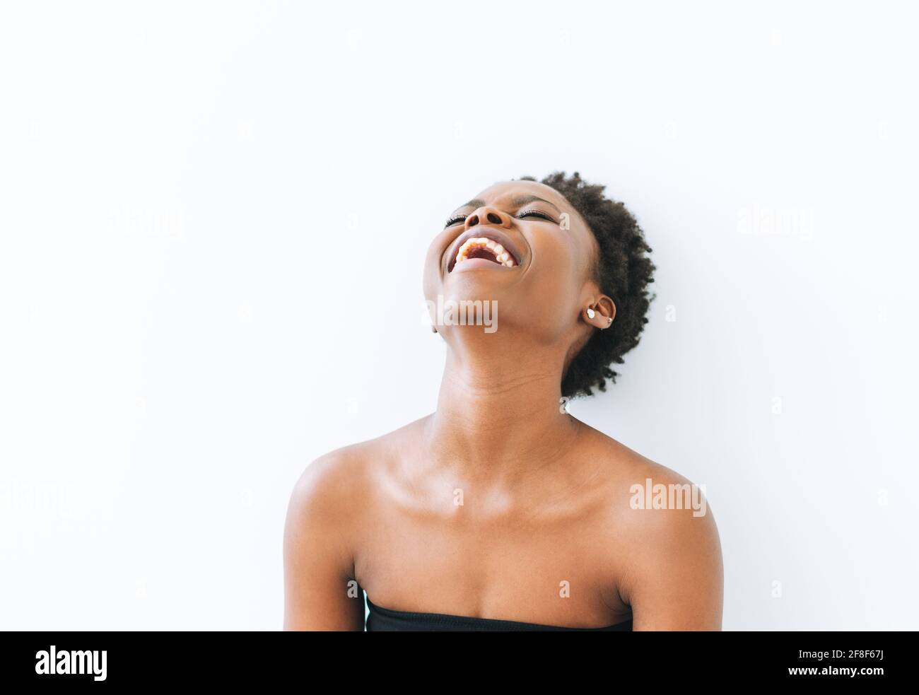 Portrait of happy beautiful young African American woman in black top ...