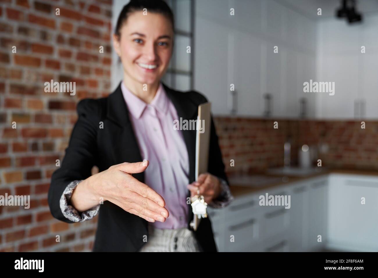 Real estate agent reaches out for a handshake Stock Photo