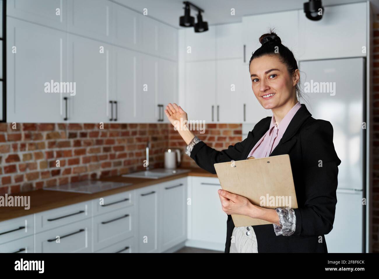 Real estate agent agent invites you to view the apartment Stock Photo