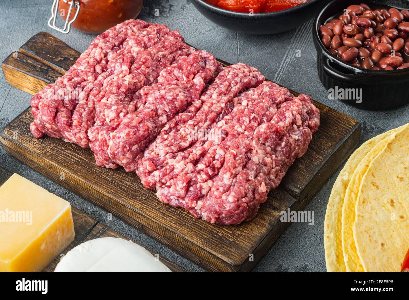 Ingredients for mexican quesadilla with salsa, on gray background Stock Photo