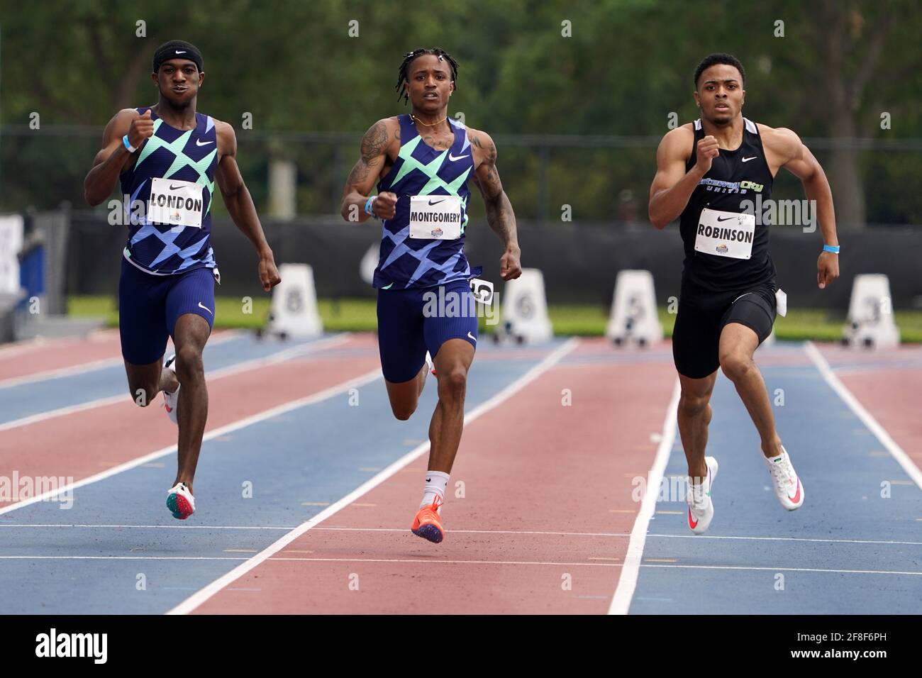 Justin Robinson (USA), right, defeats Wil London (USA), left, and Kahmari Montgomery (USA) to win the 400m in 45.23 during the Miramar Invitational, S Stock Photo