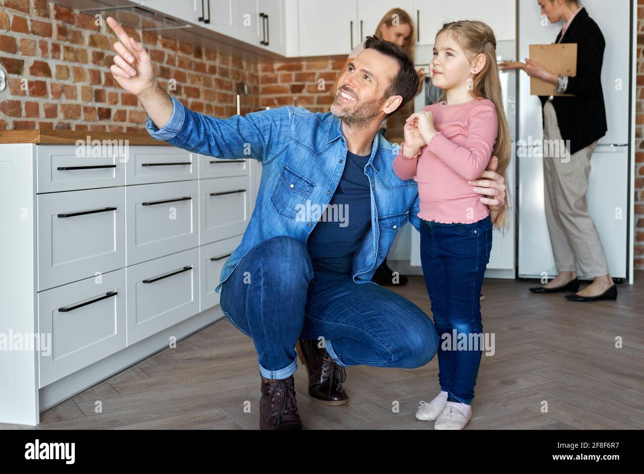 Happy family watching a new apartment before buying Stock Photo