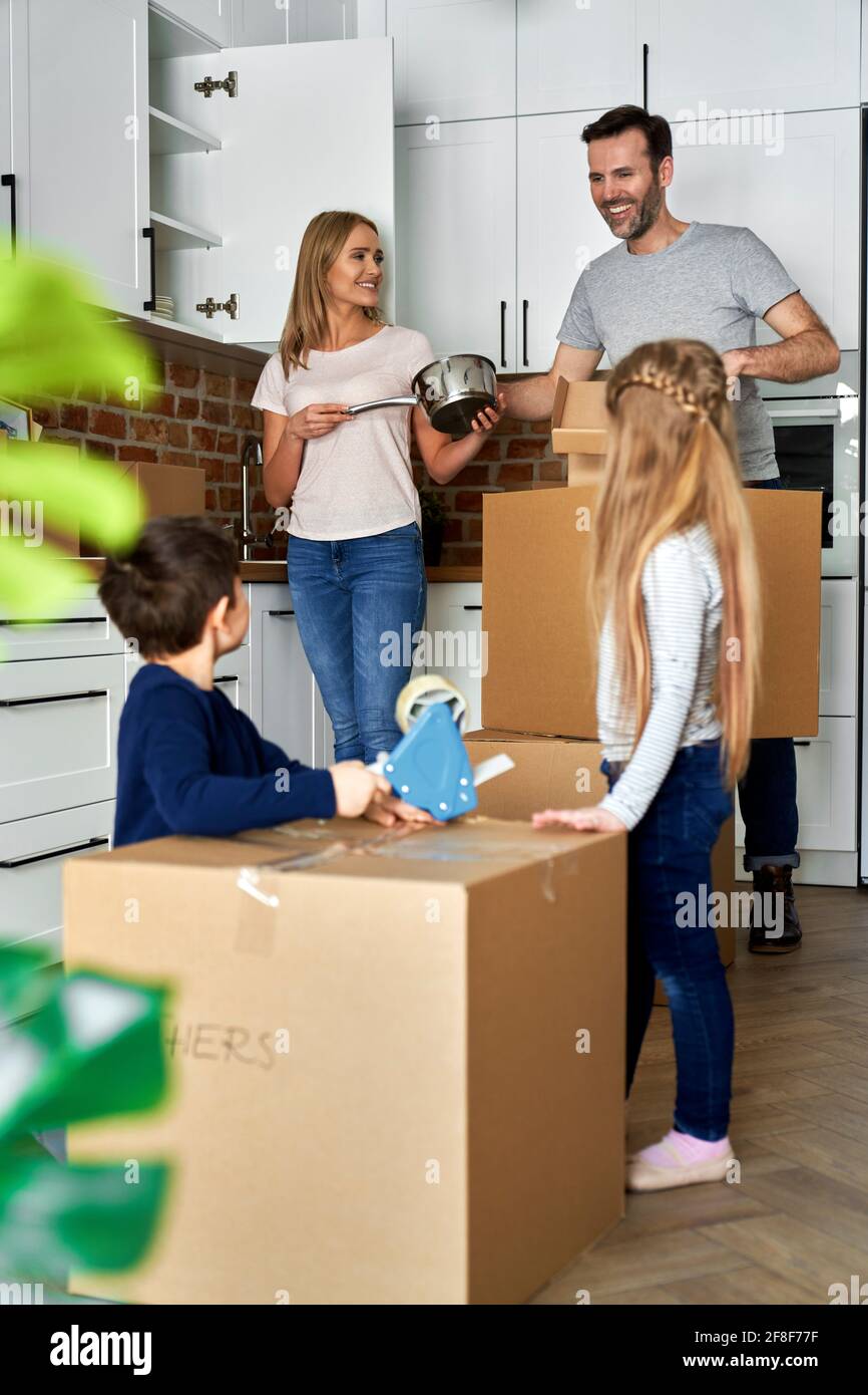 Happy family with children moving to a new home Stock Photo - Alamy