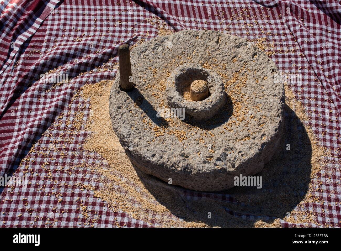 Handmade manual equipment grind mill. Traditional stone handmill Stock