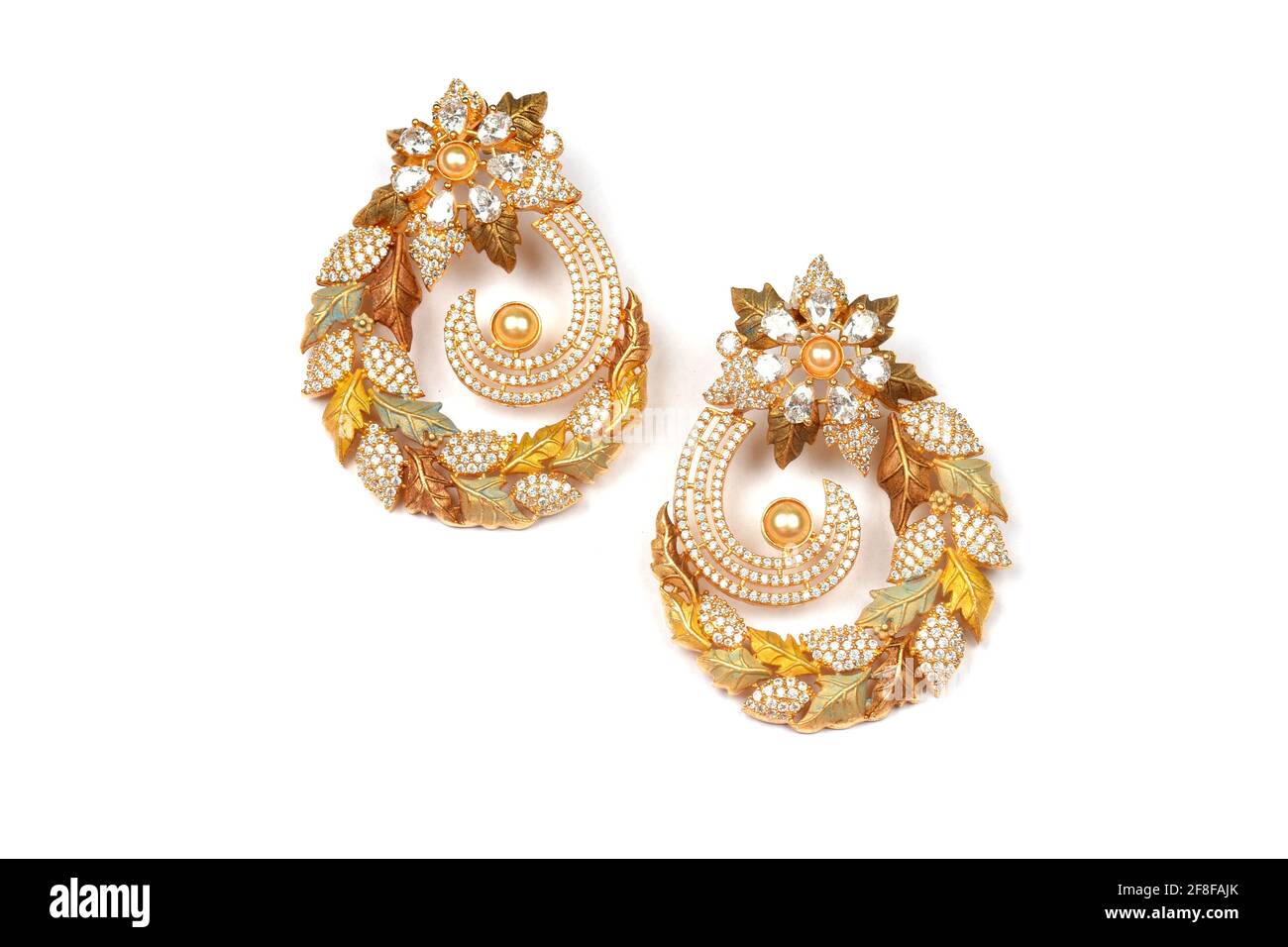 Glamorous antique Golden pair of earrings on white background Indian traditional jewellery, Bridal Gold earrings wedding jewellery, Vintage earrings Stock Photo