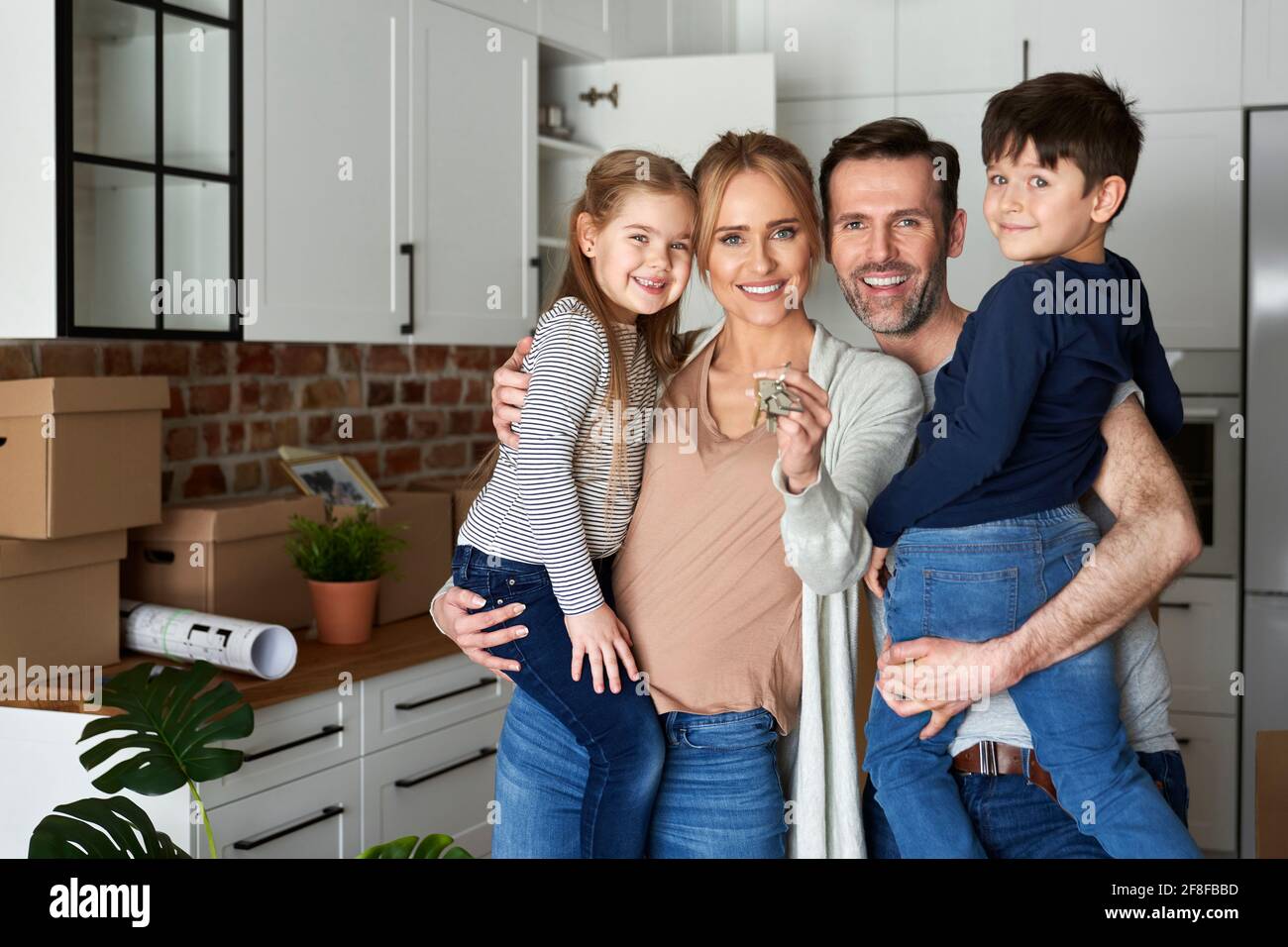 Portrait of family with children holding key for a new apartment Stock Photo