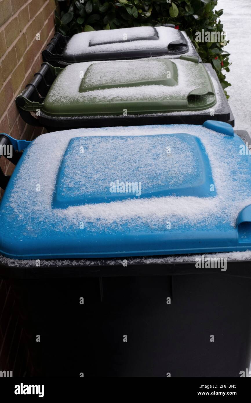 Frost covered council recycling bins for household waste, recycling and