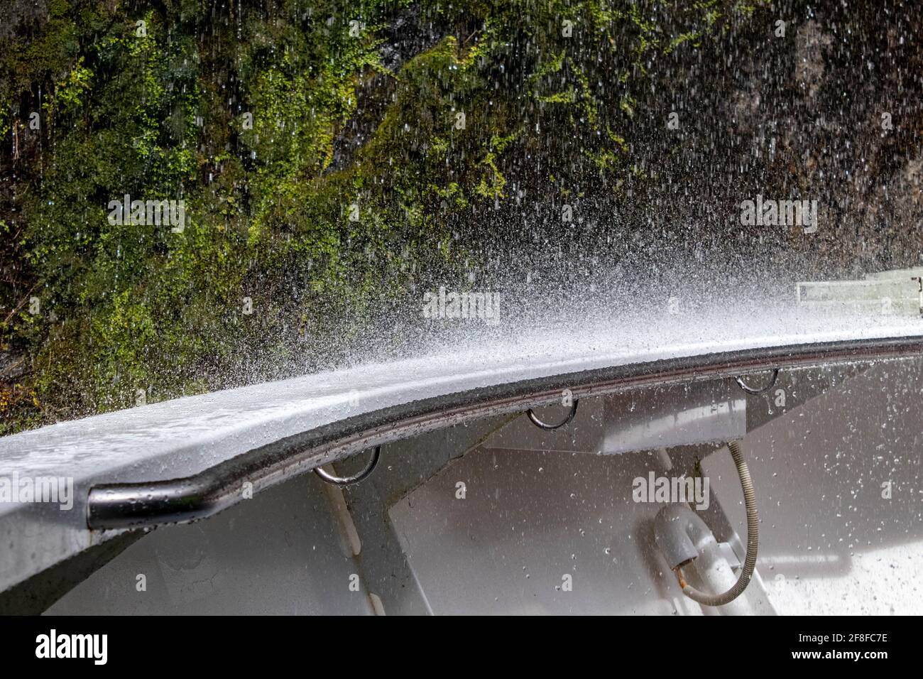 Waterfall drops splash off of the back of a boat Stock Photo