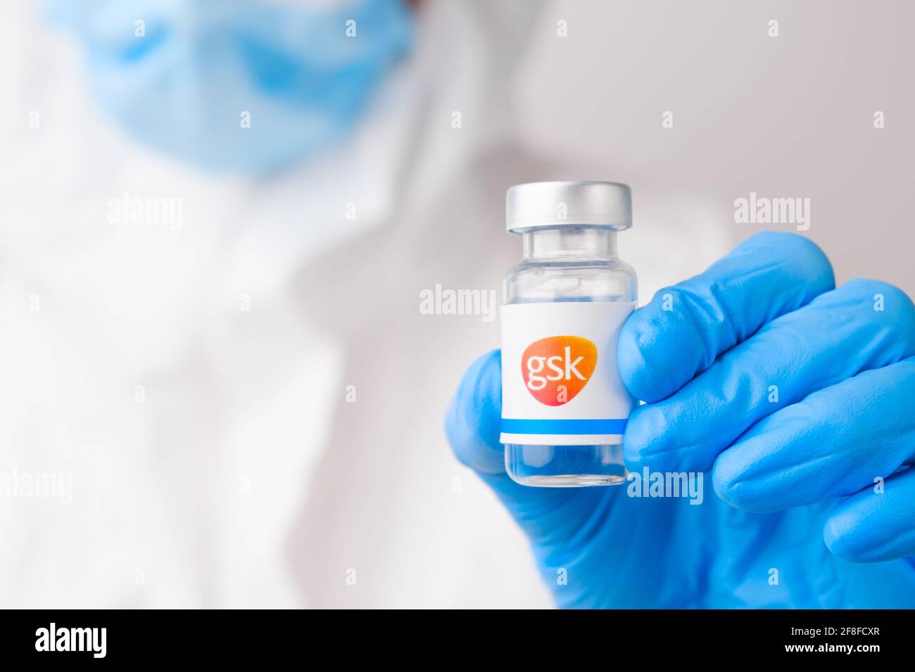 GSK vial or bottle with pharmaceuticals demonstrated by health worker or scientist in rubber gloves, April 2021, San Francisco, USA  Stock Photo