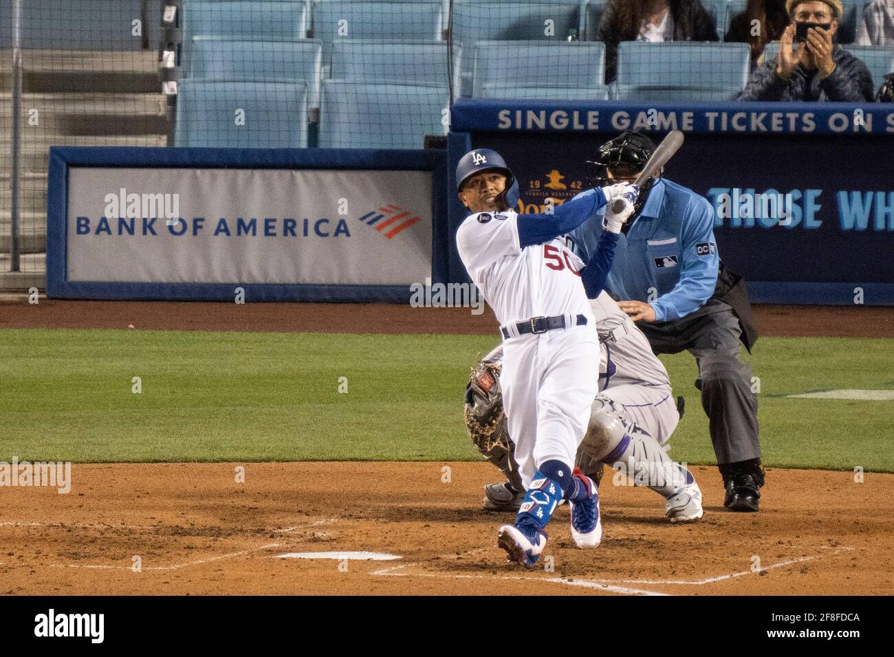 Los Angeles Dodgers right fielder Mookie Betts (50) homers to left field  during a MLB game against the Colorado Rockies, Tuesday, April 13, 2021, in Stock Photo