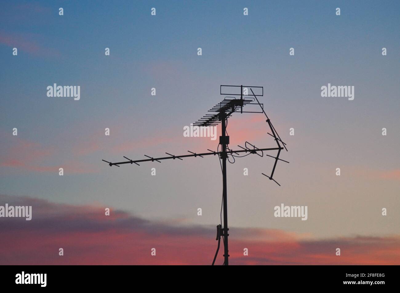 TV antenna with beautifule envening clouds. Stock Photo